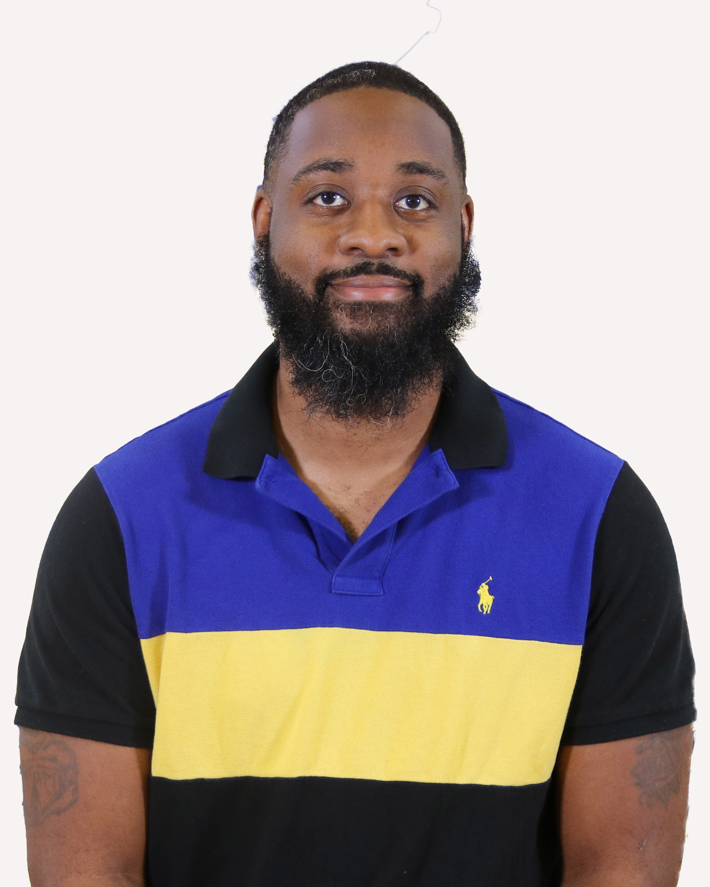 Man with beard wearing a striped polo
