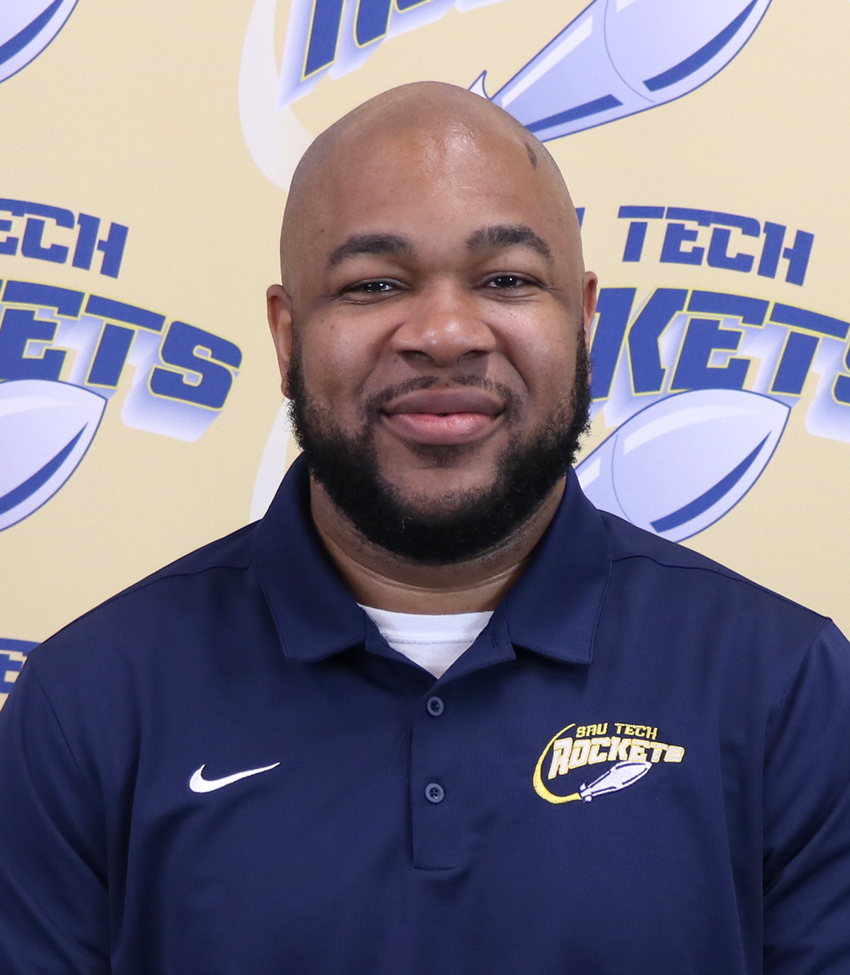 African American man in dark blue polo shirt